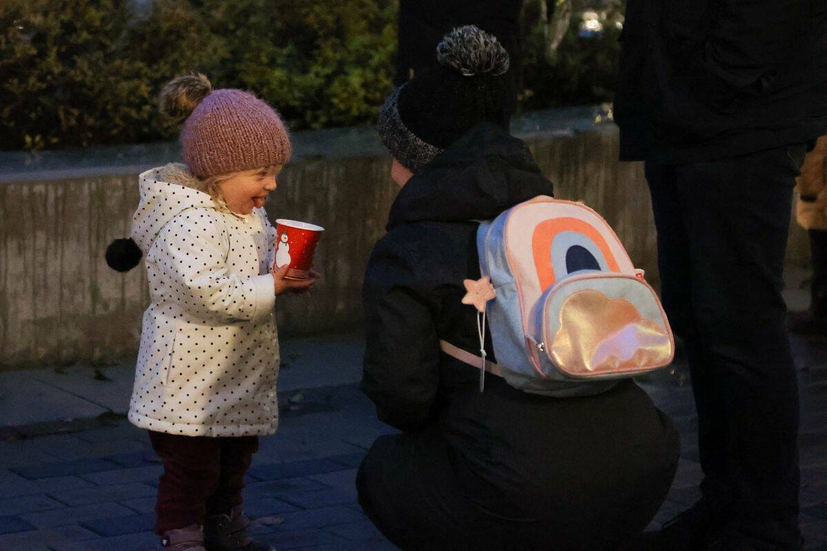 A young girl drinks hot choclate at the Christmas on the Peninsula festival in Miramar Village Plaza in White Rock on Nov. 26. (Photo: Anna Burns)