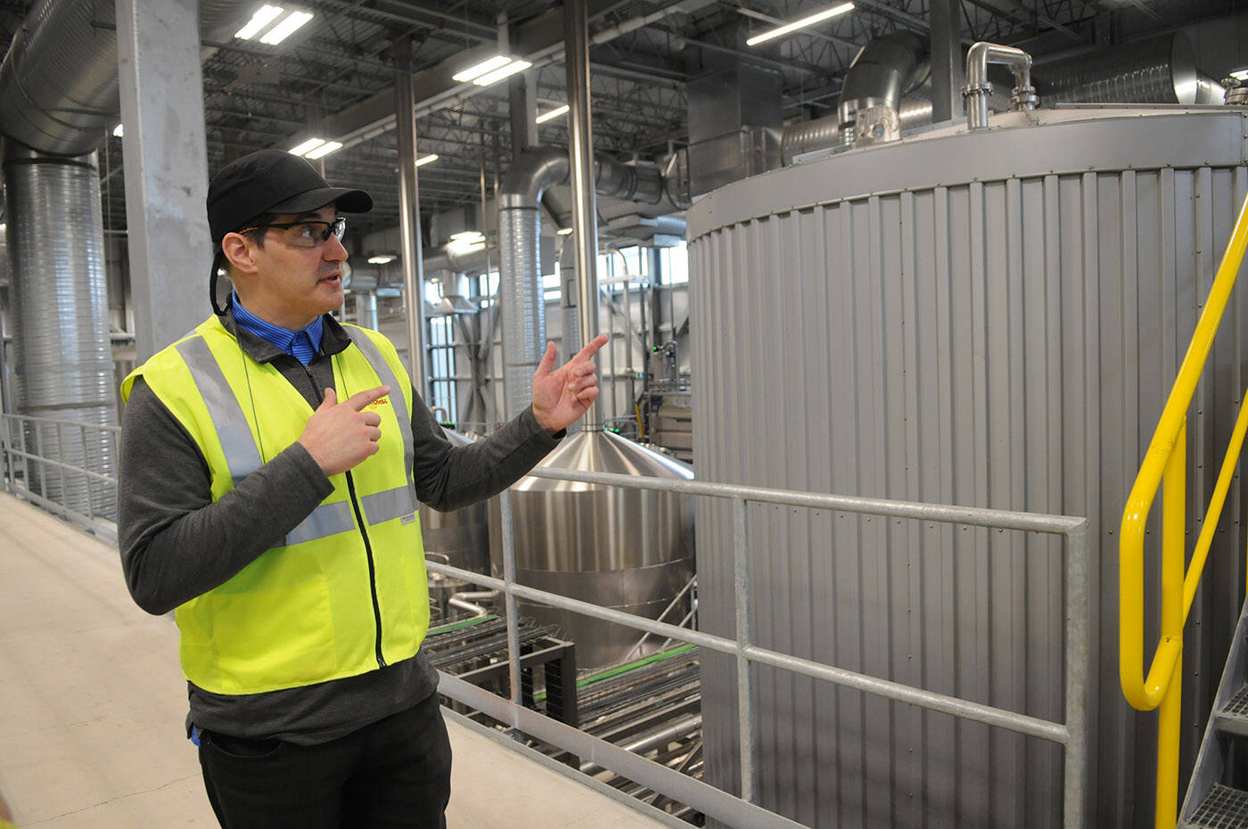 David Hamel, Molson Coors general manager of operations for Western Canada, is seen on March 17, 2022 by a tank (right) that was converted to produce malt and spirit-based beverages at the Chilliwack brewery. (Jenna Hauck/ Chilliwack Progress)