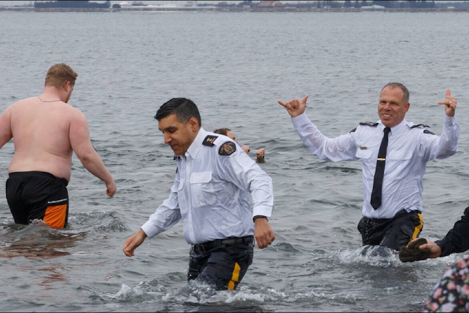 Surrey RCMP officers, firefighters and athletes participated in the Polar Plunge for Special Olympics BC, held Saturday (Feb. 25, 2023) in Crescent Beach. (Anna Burns photo)