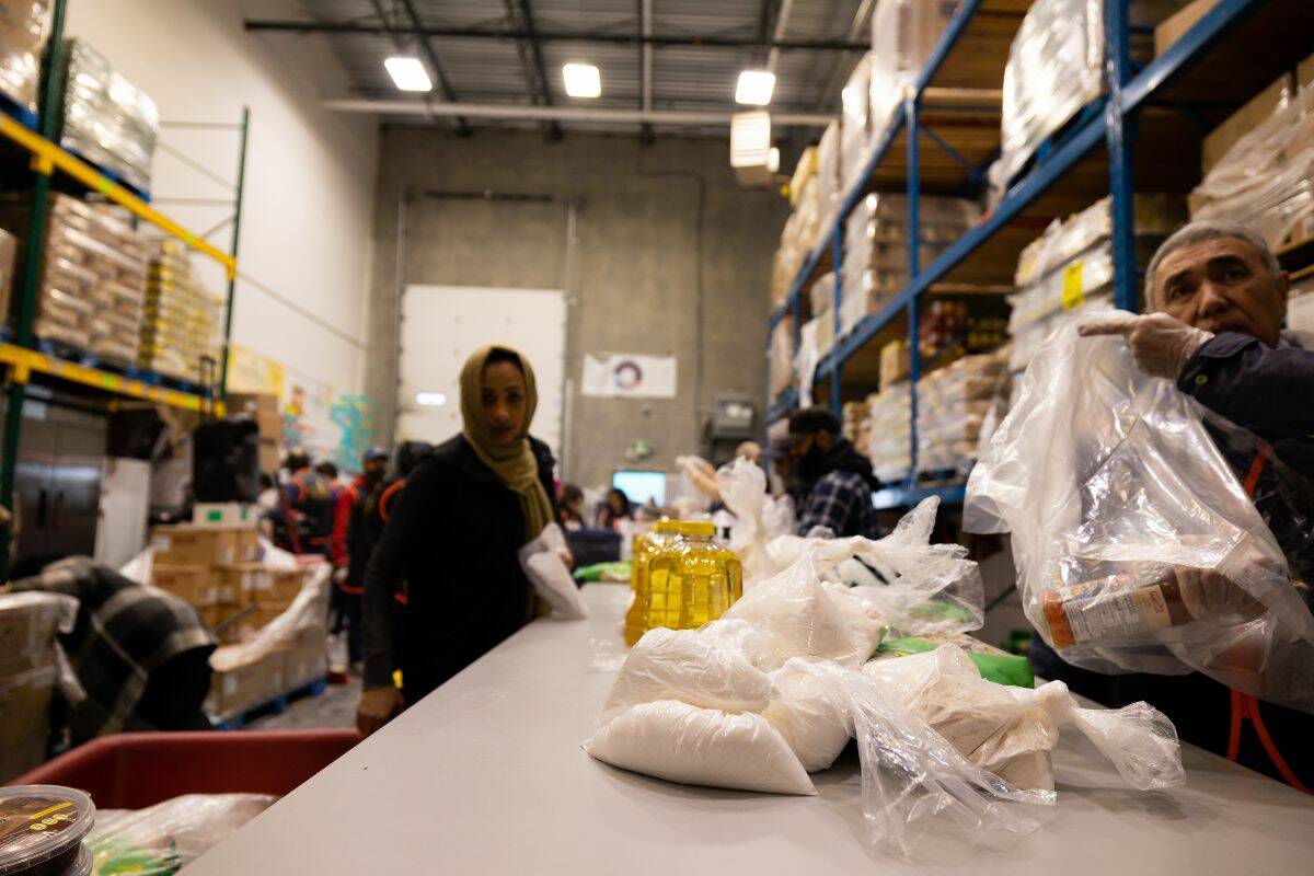 Volunteers packing food hampers at the Muslim Food Bank in Surrey on Saturday, March 4, 2023. (Photo: Anna Burns)