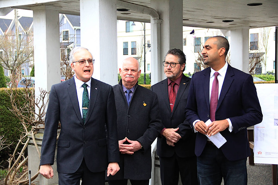 Mike Garisto, president and chief operating officer Columbus Homes (left), thanks Ravi Kahlon (right), Minister of Housing, for the government grant, alongside Mike Starchuk, MLA for Surrey-Cloverdale (second from right), and Garry Begg, MLA for Surrey-Guildford. (Photo: Malin Jordan)