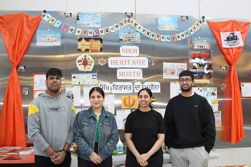 Students Gaurav Saroa (Grade 11), Raya Kaur Sandhu (Grade 12) and Ajaypal Singh Grewal (Grade 11) stand in front of a magnetic wall with Sikh Heritage Month and Vaisakhi displayed for the month at L.A. Matheson Secondary. The students pictured and more have been leading how the two events are marked at the school, with the assistance of their teacher Gurpreet Bains (second from left). (Sobia Moman photo)