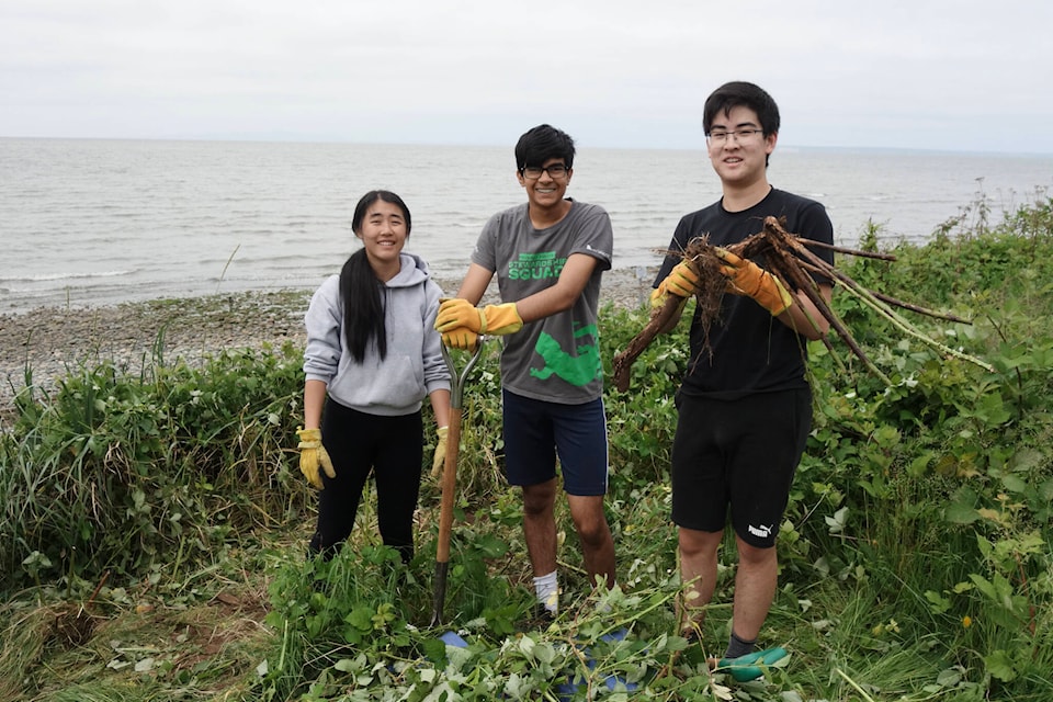 Semiahmoo Secondary students Cheryl Chen, left, Jashandeep Singh and Yoyo Liu helped more than 40 Lower Mainland Green Team volunteers clean up West Beach in White Rock on Sunday (May 28). (Contributed photo)
