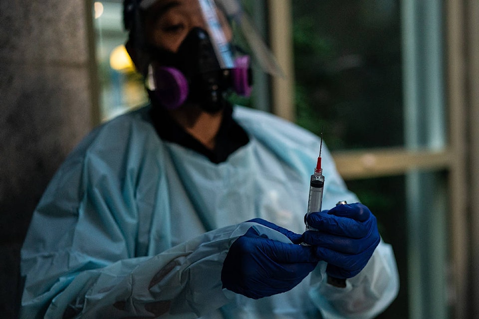 A paramedic from B.C. Ambulance prepares a large dose of Naloxone as they respond to a drug overdose in downtown Vancouver, Wednesday, June 23, 2021. Over the past several years the drug overdoses not only across British Columbia but throughout Canada have but grown. On June, 23, 2021 for instance B.C. Ambulance paramedics responded to 140 overdose calls across the province with 42 of those being just in Vancouver. THE CANADIAN PRESS/Jonathan Hayward