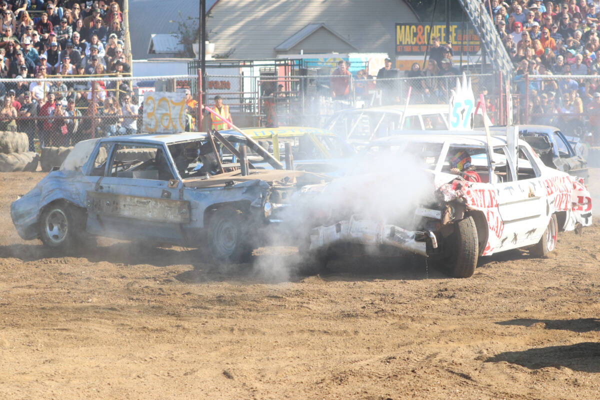 George Dover from Mission, in Car 327, rams the raffle car driven by Salmon Arms Miranda Bischke during the opening heat the 2022 Armstrong Demolition Derby Sunday, Oct. 9, at the IPE Grounds. (Roger Knox - Black Press)
