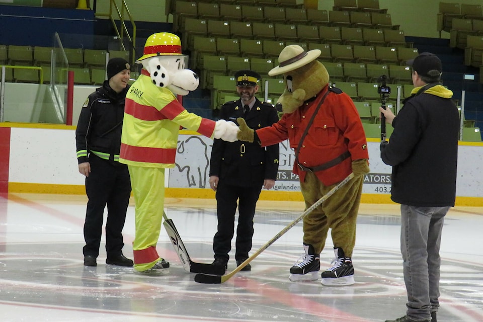Sparky the Dog vs Safety bear shaking hands as part of the Guns n Hoses charity fundraiser in Kitimat, B.C. on Thursday morning (Jan. 19, 2023) (Contributed by Sandra Capezzuto)