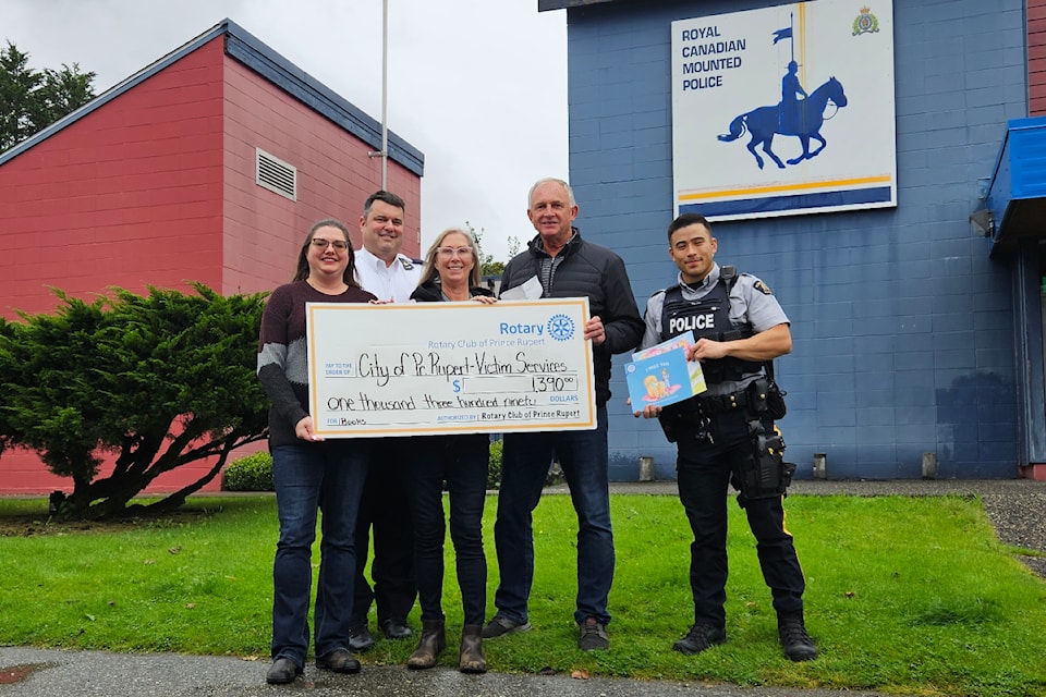 The Rotary Club of Prince Rupert donates $1,390 to Prince Rupert Victim Services to buy books for their child clients to read. From left: Rotarian Melissa Ash; RCMP Inspector Gerald Walker (also a Rotarian); Joyce Charlton, Prince Rupert Victim Services manager; Rotarian Richard Wright; and Const. Cody Slavik outside the Prince Rupert RCMP detachment on Sixth Avenue.