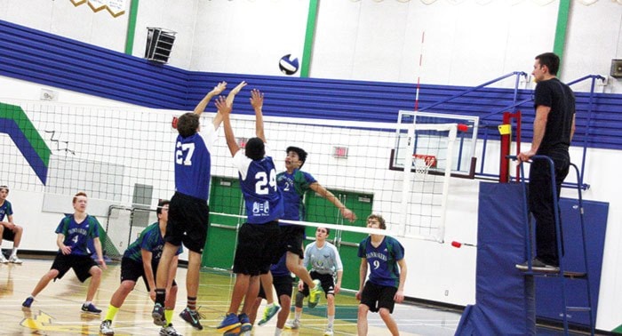 Kevin Rioux attempts to block a spike by Queen Charlotte SS. Oct 25, 2014