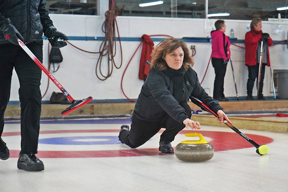 Shar Edwards throws a rock early in the final game for the Bulleid rink at the mixed-curling bonspiel inside the Prince Rupert Curling Club. (Shannon Lough / The Northern View)