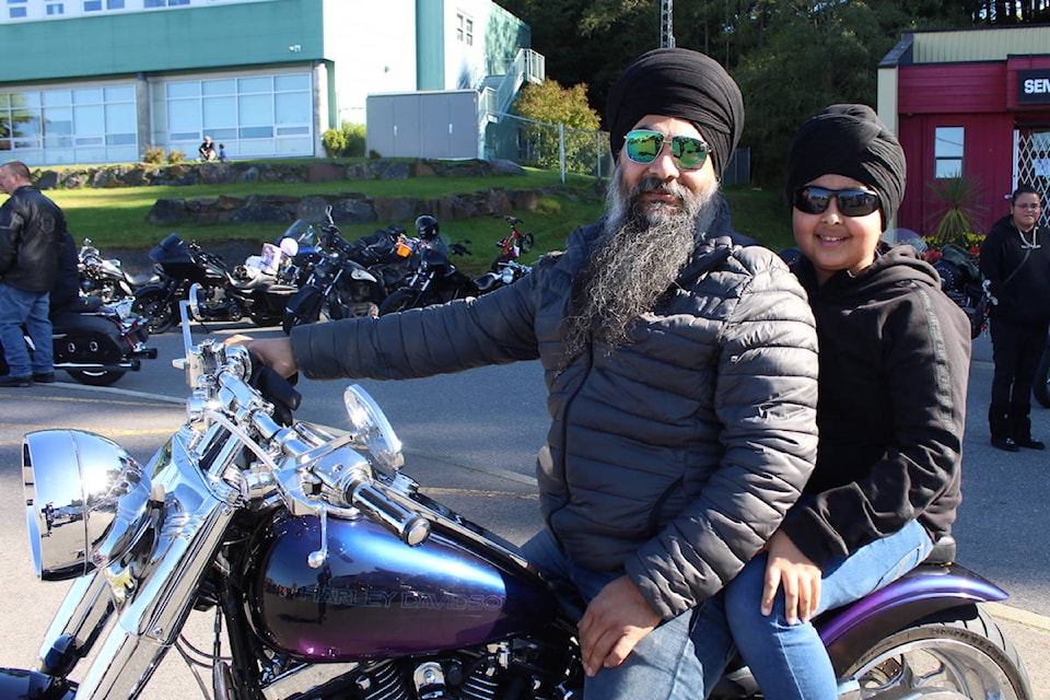 Sharanjit Singh and his son Sahibjot taking part in their first Toy Run upon Sharanjit’s custom Harley-Davidson Fat Boy. (Alex Kurial / The Northern View)