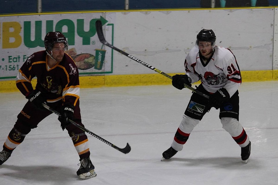 Cole Atchison of the Rampage keeps an eye on Quesnel’s Adam Chapman during Prince Rupert’s 4-1 victory on Friday night. (Alex Kurial / The Northern View)