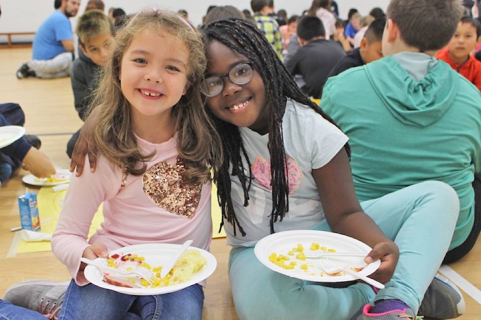 Students at Conrad Elementary School celebrated Thanksgiving early by taking part in a Friday feast on Oct. 4. Ham, potatoes, vegetables and jello were all part of the offerings, which the students and teachers enjoyed seated at decorated paper ‘tables’ placed on the gym floor. The food was made by volunteers, and served by teachers and students alike. (Alex Kurial / The Northern View)