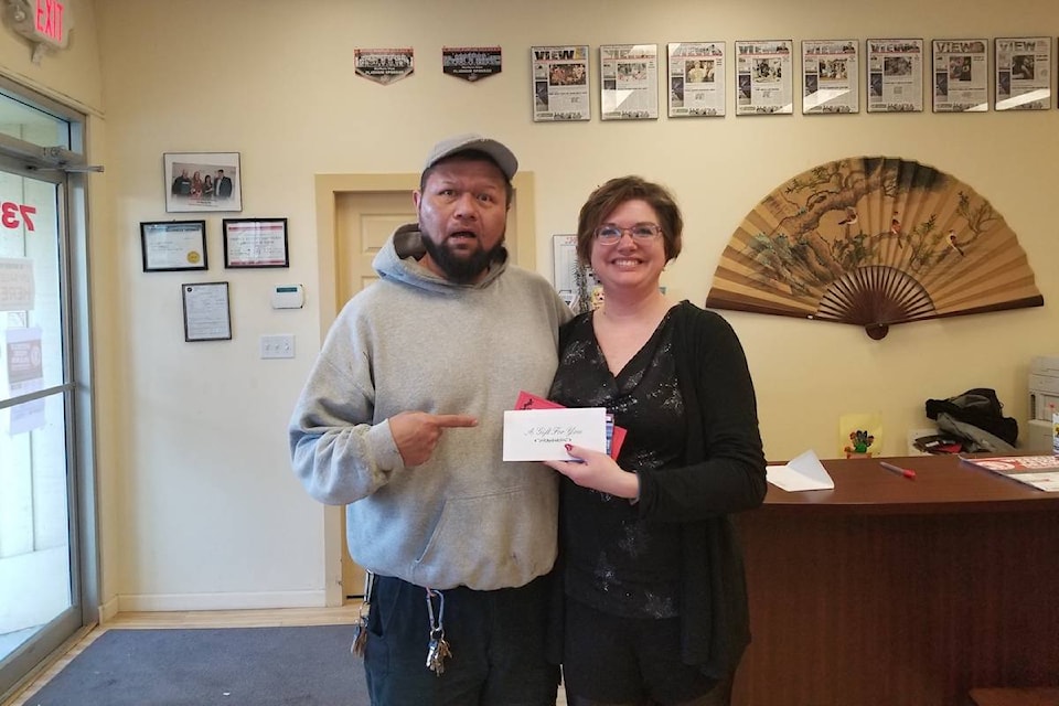 Rob McKay with office manager Melissa Boutilier at The Northern View. Winner in week one of Santa Shops Here. (The Northern View file photo)