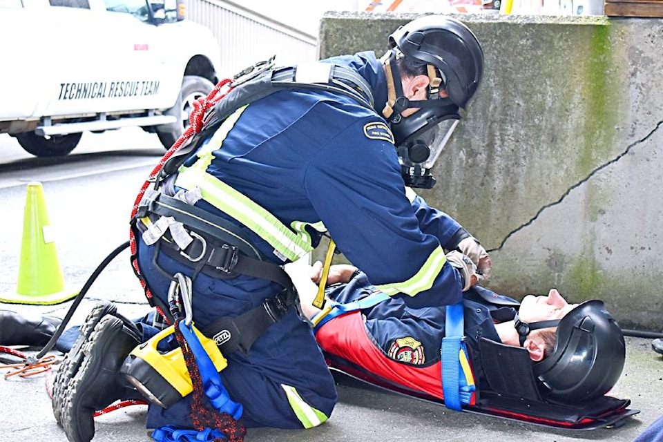 Prince Rupert Fire Rescue crews work on confined spaces rescue certification on July 8, 2020. A fire fighter is strapping a victim to a board to escape to safety in a simulation training. (Photo: K-J Millar/The Northern View)