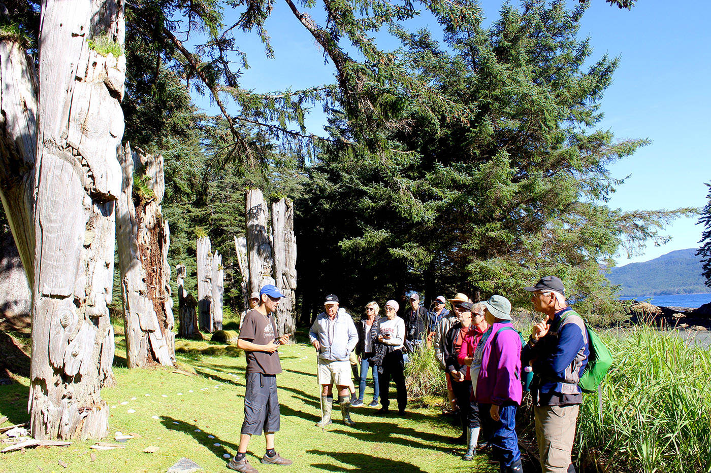 A Haida Watchman shows visitors around the Sgang Gwaay village site in 2017. (Photo: Amy Attas)