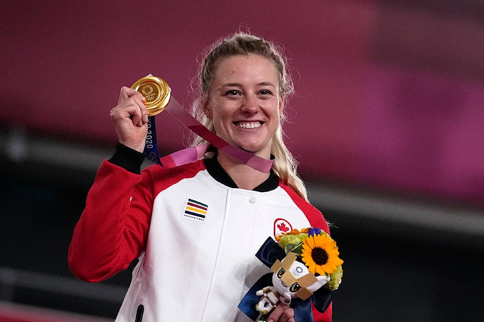 Gold medalist Kelsey Mitchell of Team Canada reacts during a medal ceremony for the track cycling women’s sprint race at the 2020 Summer Olympics, Sunday, Aug. 8, 2021, in Izu, Japan. (AP Photo/Christophe Ena)