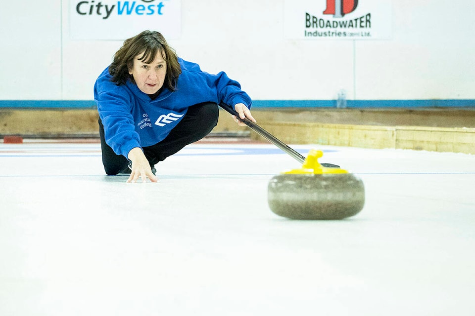 Natasha Lebedic watches her curling rock slide down the ice at the Prince Rupert Curling Club’s Ugly Christmas Sweater Sturling Speil on Dec. 4, 2021. The tournament was the first held in two years. (Photo: Norman Galimski/The Northern View)
