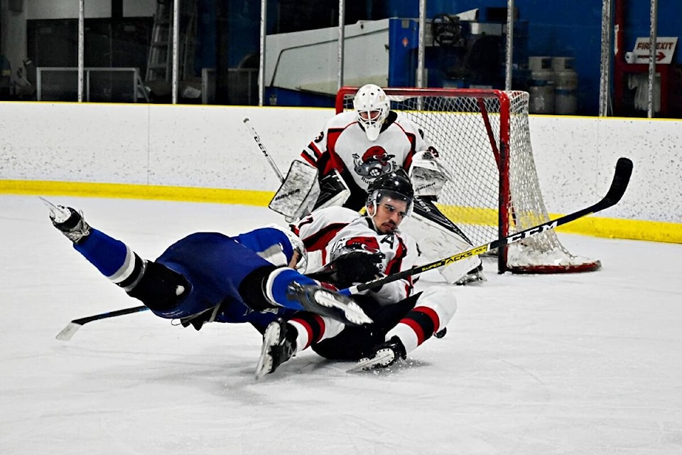 Two players tumble in game one, on March 4 of the best of three playoff series between Rupert Rampage and Terrace Rivers Kings.