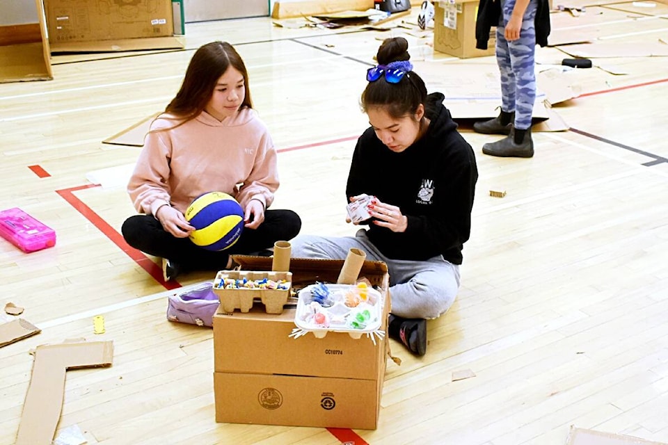 Taegan Jeffrey-Stewart and her sister Halli hard at work during the Cardboard Challenge at Pineridge Elementary School May 19. (Melissa Ash/ The Northern View)