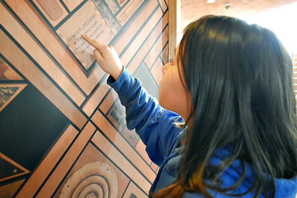 Zoey Martin, Grade 4 student at Conrad Elementary reads a panel on the replica Witness Blanket on display at the Lester Center on May 26. (Photo: K-J Millar/The Northern View)