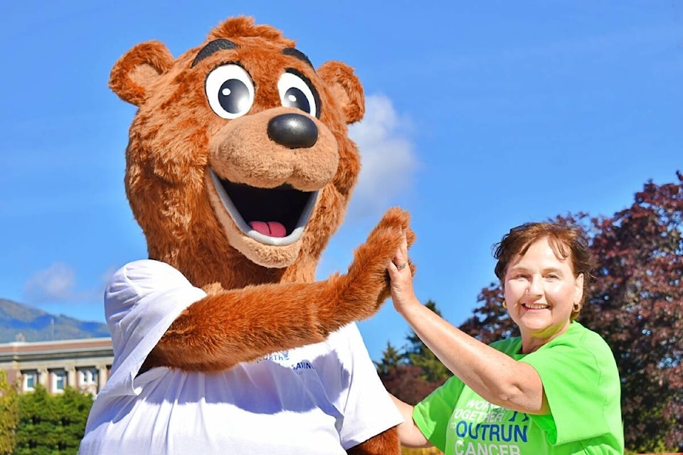 The 2022 Terry Fox Run stepped off with high-fives all around from Northern Savings Credit Union employee and volunteer for the event Heidi Harris and NSCU’s mascot bear Griswald (Photo: K-J Millar/The Northern View)