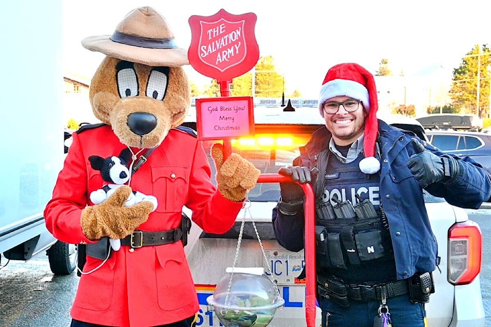 Officer Gabe Gravel and RCMP Safety Dog collected donations and toys at the Prince Rupert Cram-a-Cruiser event at Safeway on Dec. 10. Safety Bear holds a special hand-knitted toy donation. (Photo: K-J Millar/The Northern View)