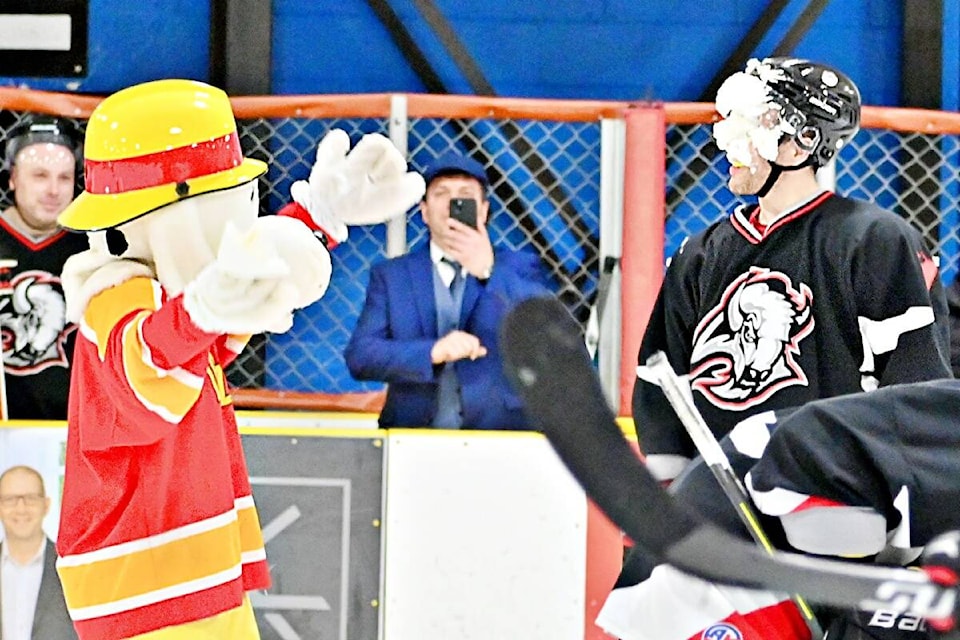 Sparky the Fire Rescue dog gets a little cheeky with his game on throwing a pie in the face of the opposing team’s player RCMP Const. Brody Hemrich at the Guns-N-Hoses charity hockey game on March 11. (Photo: K-J Millar/The Northern View)