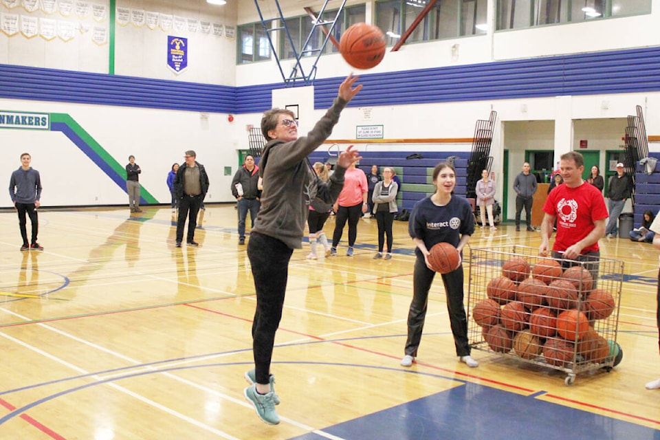 North Coast MLA Jennifer Rice takes a shot during the Rotary Club’s annual Hoop-A-Thon. The event raises funds for Charles Hays Secondary School’s food program and the Rotary’s apple program. Emcee Doug Kydd, said the apple program alone has grown to $3,500 per year. Club president Ellen Witherly said once all the donations are counted the Hoop-A-Thon will exceed its goal of $6,500 and top $7,000. (Thom Barker/Black Press Media)