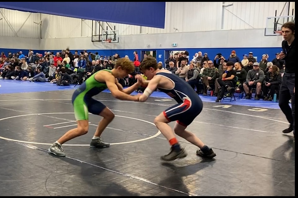 PHSS Grade 9 student Hunter Stagg locks up against Queen Margaret School's Kalem Thomas in the first round of the 66kg division at the Island Championships in Duncan. (Tyson Whitney photo)