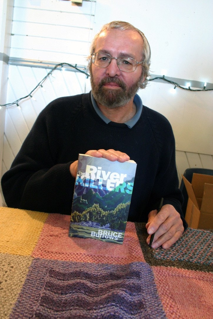 Bruce Burrow with his book The River Killers