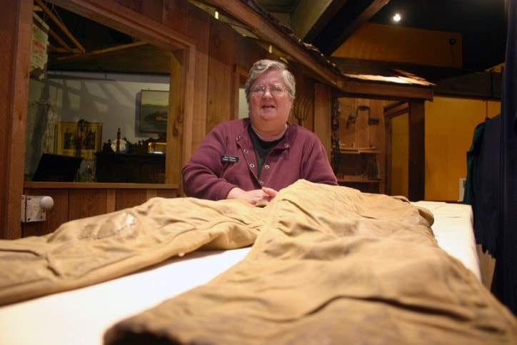 Port Hardy Museum curator, Jane Hutton, with a pair of old school "tin pants."