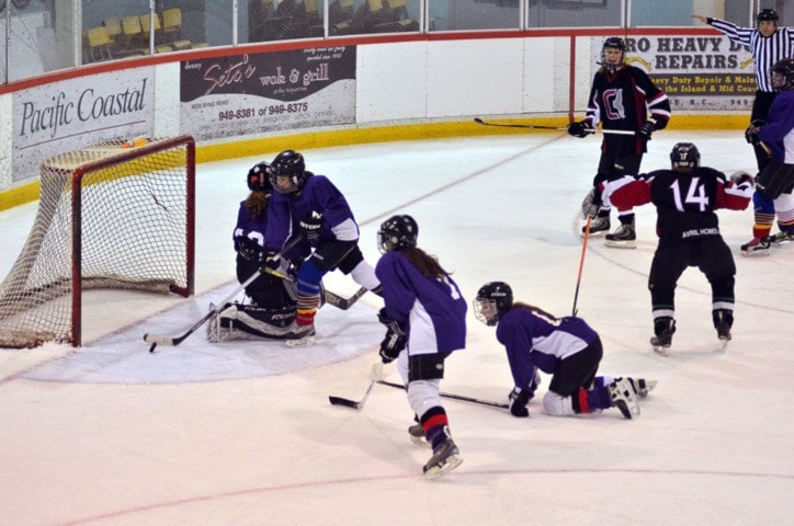 Jamie Demoe clears the puck after No.14 Lynn Slaby's shot rattles both posts.