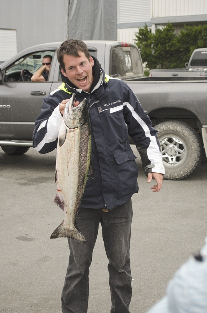 Chris Denton poses with his catch at the weigh-in station Sunday.