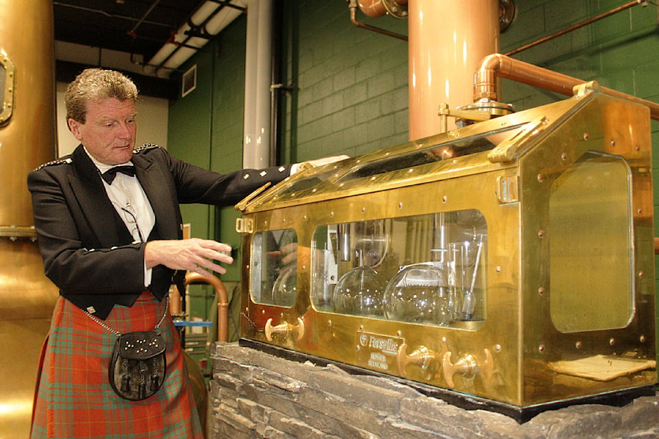 Graeme Macaloney, whisky maker and owner of Macaloney’s Caledonian Distillery, explains how the distilled spirits flow through the pot stills before being transferred into barrels to age. (Devon Bidal/News Staff)