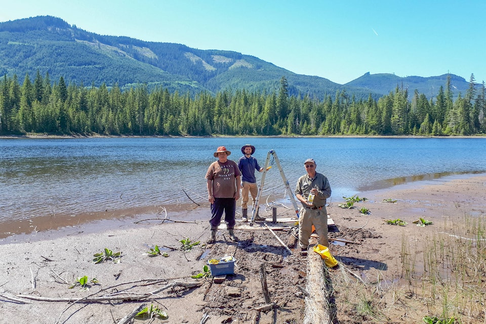 Researchers recovering a core from Little Woss Lake. Photo Duncan McLaren