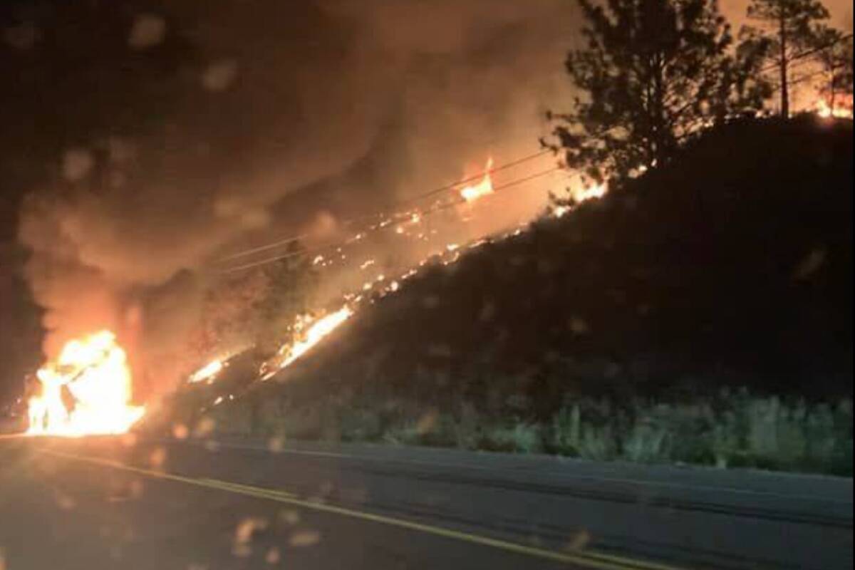 Flames from a vehicle fire on Highway 3 spread up hill. (Facebook)