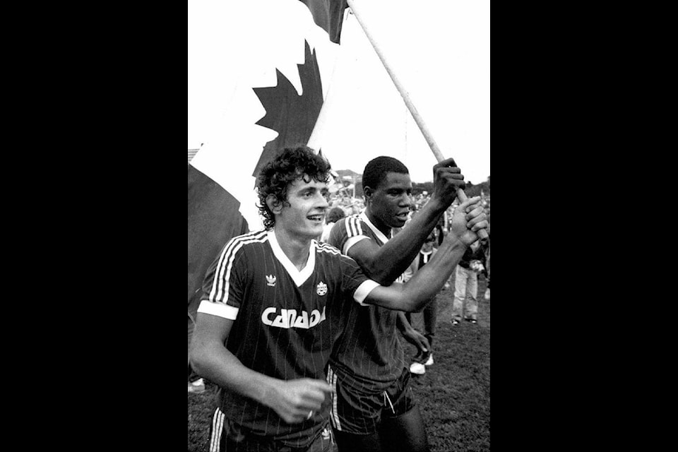 Canadian national soccer team players Paul James (left) and Randy Samuel celebrate the team’s 2-1 win over Honduras in St. John’s, Nfld. in this 1985 file photo. THE CANADIAN PRESS/Michael Creagan