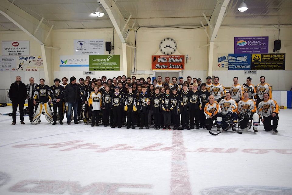 North Island Eagles teams, coaches, and of course the alumni players all stopped for a group photo at the end of the game. (Tyson Whitney - North Island Gazette)