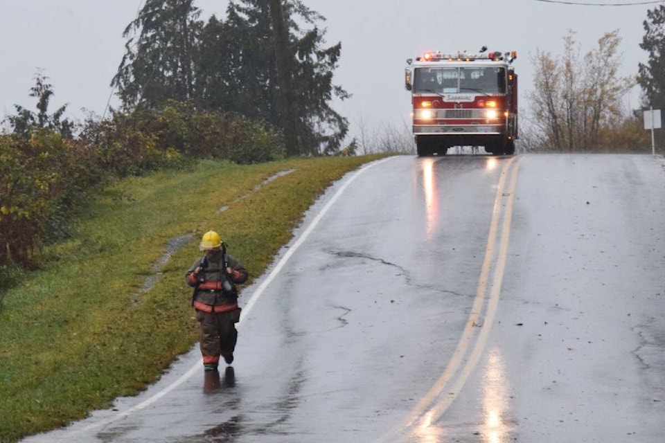 First responder Greg Beatty walking in full turnout gear in the rain to raise funds for Movember. (Debra Lynn photo)