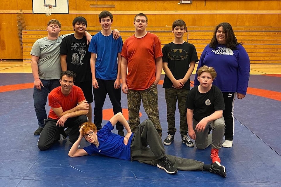 Eight students came out to train wrestling at the Port Hardy Secondary School gymnasium on Wednesday, Dec. 14. Top row, left to right: Rylan France, Karl Baraceros, Nathaniel Fralic, Brodie Chambers, Auzton Shaw, Finn Nelson. Bottom row, left to right: Athletic director Paul Cagna, Jorden Strussi, and Carter Chaston. (Tyson Whitney - North Island Gazette)