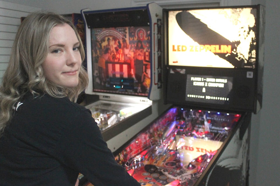 Ally Badger, Mid Island Pinball League member, racks up a high score on a Led Zeppelin pinball machine at Curious Comicon in Nanaimo on May 6. (Karl Yu/News Bulletin)