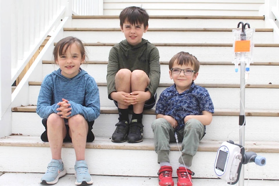 Isabel, left, Spencer and Simon take a break on the steps of their Oak Bay home. The Hoskins family hopes to raise awareness of Simon’s condition ahead of International MPS Awareness Day on May 15. (Christine van Reeuwyk/News Staff)