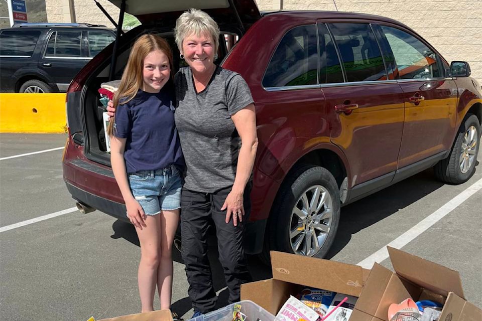 (from l): Grade 6 student Hannah Gerow (with a rescue friend from Better Beginnings Kitten Rescue) and Carleen Stamer (with donations for the rescue group) on June 5 in Kamloops. 