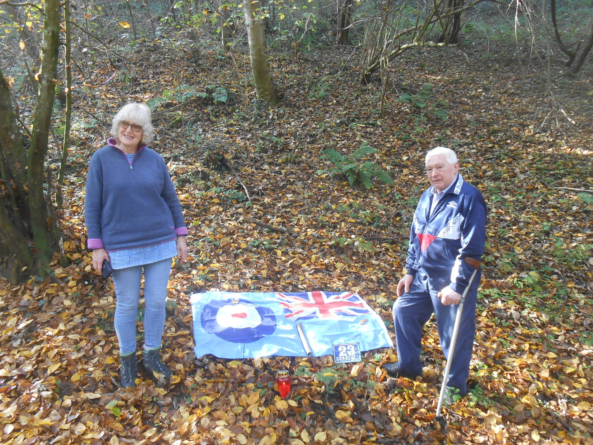 Heather Maling and Zvonko with a flag and candle at the crash site. Photo: Submitted