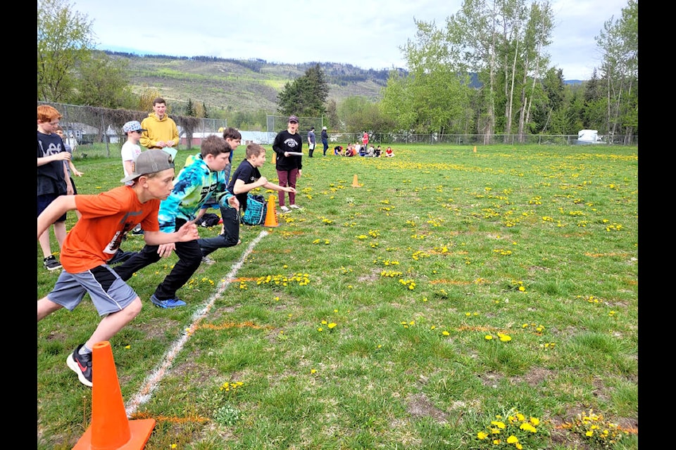 Ready, set, go! Barriere Elementary School students charge across the starting line during the school’s track and field day held on May 11. (Pictured right) Long jumper Erik Fraser heads into his jump. (M. Brogan photos)