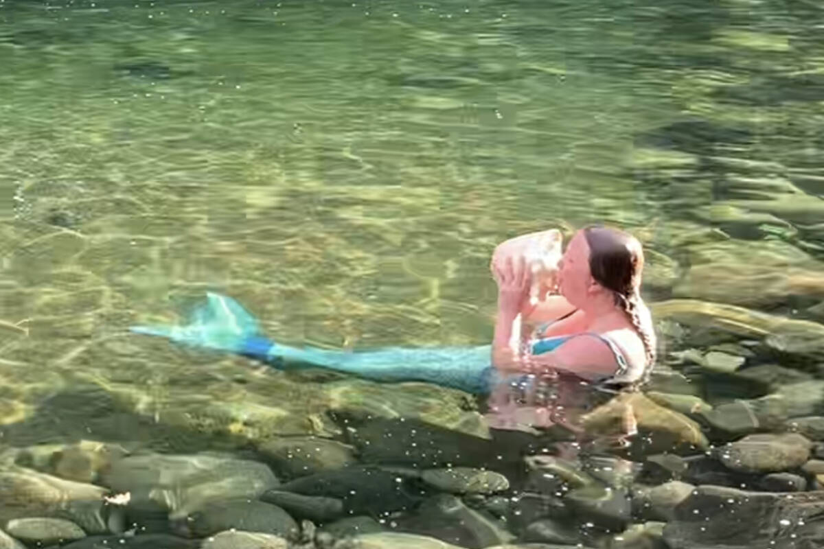 French horn musician and Royal Canadian Navy Naden Band member Alliszon Zaichkowski plays one of her 20 conch shells in the water while dressed as a mermaid. Mainly specializing in classical music, Zaichkowski spent 10 years perfecting Queens Bohemian Rhapsody before taking the act to Canadas Got Talent. (Courtesy of Alliszon Zaichkowski)