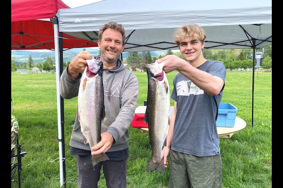 (L-r) Paul Dykstra and his son Kylar hold up the good looking trout they caught on Sunday, June 19, during the annual North Thompson Fish and Game Club’s Father’s Day Fishing Derby. Paul Dykstra won the Largest Fish with his 4.96 lb. rainbow, while son Kylar came in a close second with his 4.07 lb. rainbow. (Kathy Campbell photo)