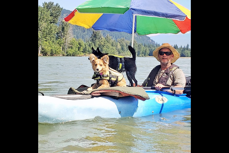 Kayaker David Nadin with crewmates Willie and Tater as they paddle down the North Thompson River, an annual event for NAdin and his wife Deleah.(Photo submitted by Deleah Nadin)