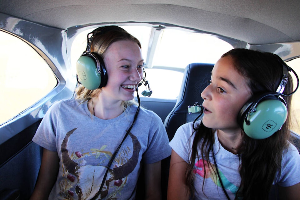 Chloe Friesen and Jaidyn Lange share a laugh as they take to the skies for the first time together. (Patrick Davies photo - 100 Mile Free Press)
