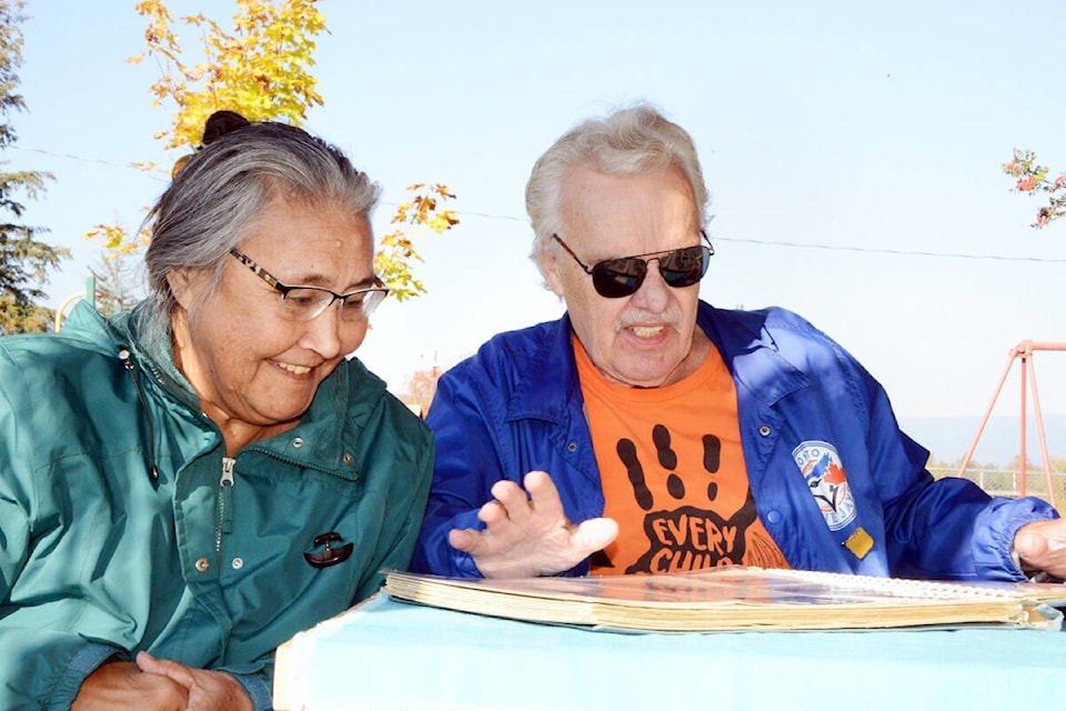 Margo Kadlun-Jones and Howie Jones reminisce as they look at a photo album from their times growing up in Canada’s North. (Times photo by Keith McNeill)
